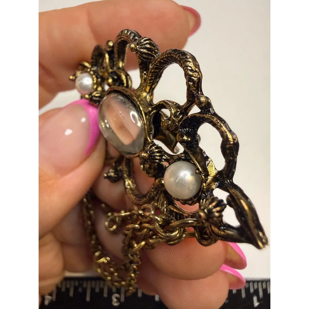 Ornate Gold Tone Filigree Brooch Faux Pearls Clear Cabochon and Triple Chain